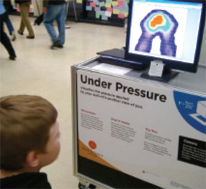 A youngster watches how, when seated, his body map changes on the Tactilus display tactilus