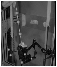 Biomechanics Figure A-1: Picture depicting wanding technique of tibial component. A Bogen arm rigidly holds the segment in place during the wanding and 4 reflective markers defining the local coordinate system are rigidly attached.