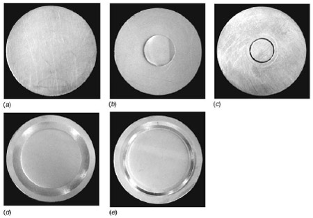 Fig. 5 CuZn30 brass disk after lapping and polishing: (a) reports the disk without indent, (b) the disk with the small area indent, (c) the disk with the small area indent after the test, (d) the disk with a large area indent, and (e) the disk with a large area indent after the test. The pictures taken after the test clearly show that the contact area (brighter ring) is inside the indent. Fig. 5 CuZn30 brass disk after lapping and polishing: (a) reports the disk without indent, (b) the disk with the small area indent, (c) the disk with the small area indent after the test, (d) the disk with a large area indent, and (e) the disk with a large area indent after the test. The pictures taken after the test clearly show that the contact area (brighter ring) is inside the indent.