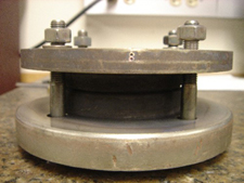 Figure 4. 12: (a) Wafer bonding chuck, showing two pieces of W-coated Si sandwiched between two pieces of W clamped by screws (b) bonded W on Si, showing (center) top view, (right) side view