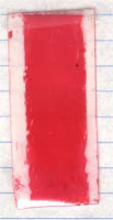 Figure 5. Pressure measuring film, medium pressure, placed on the top (left) and at the bottom (right) of the sample. The arrows indicate the location of the superconducting strand.